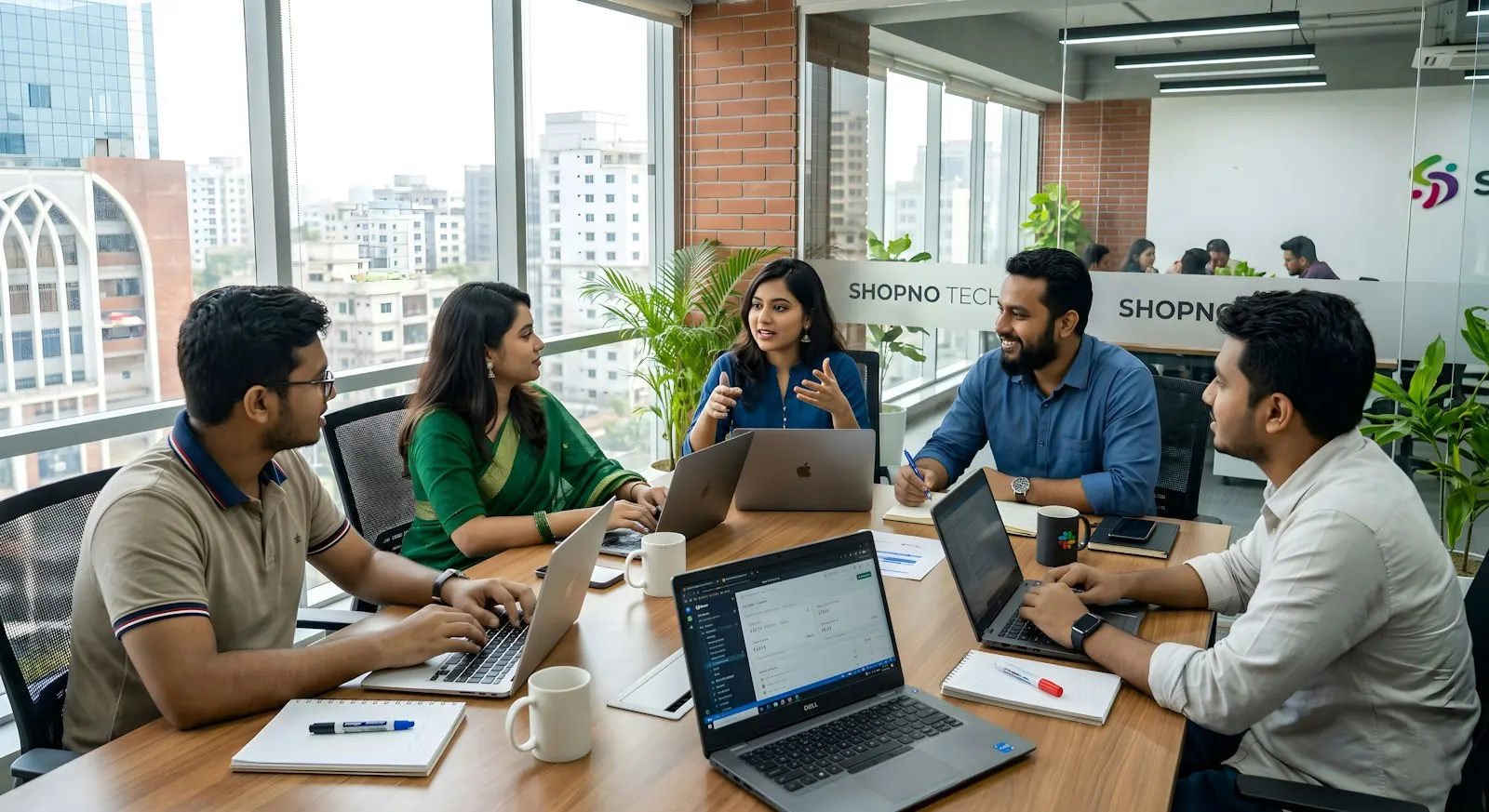 Five colleagues collaborating around a table in a modern office