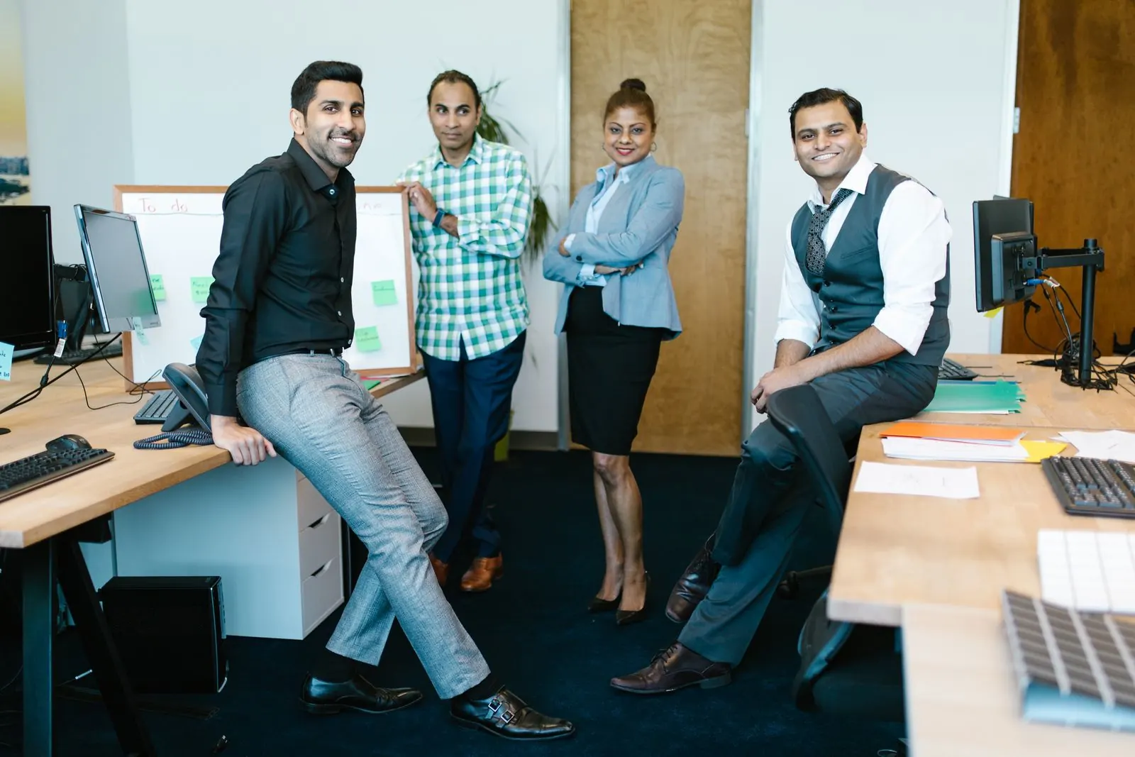 A group of happy business professionals together in a modern office